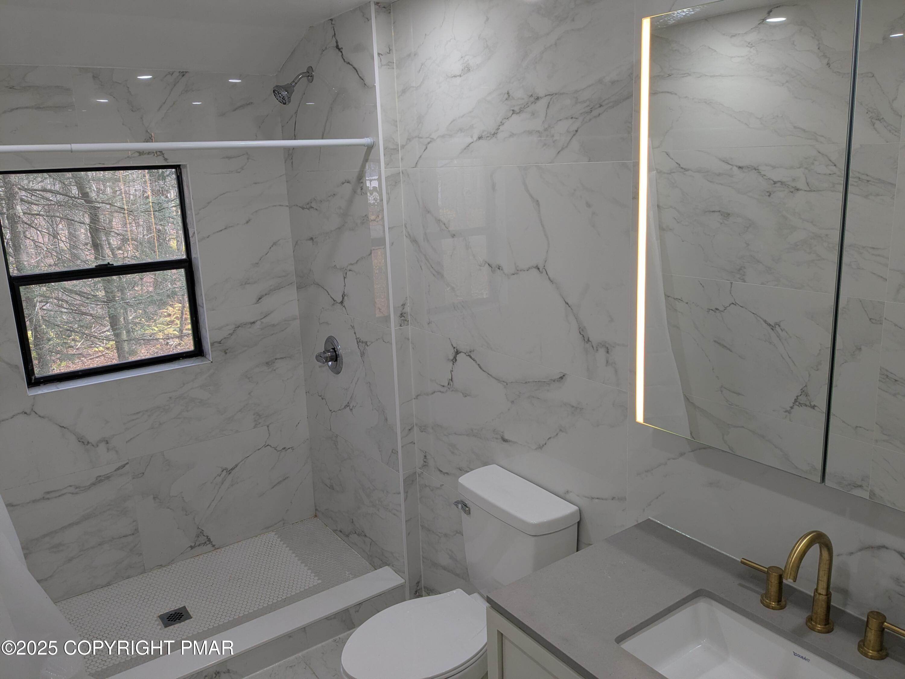 1027 Valley Road Newfoundland, PA 18445 - Photo 14 of 28 a bathroom with a toilet sink and shower