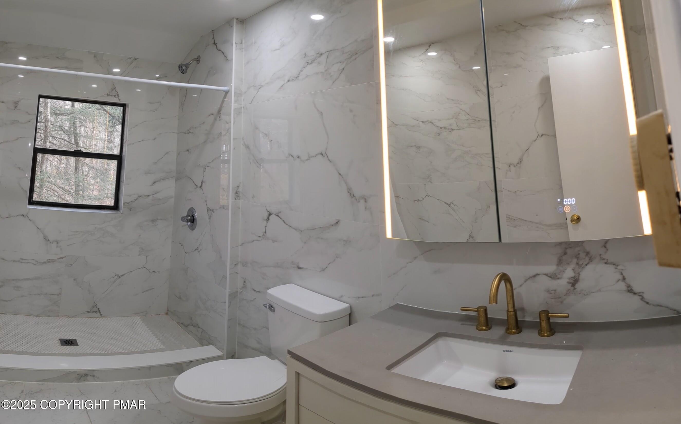 1027 Valley Road Newfoundland, PA 18445 - Photo 15 of 28 a bathroom with a sink a toilet and shower