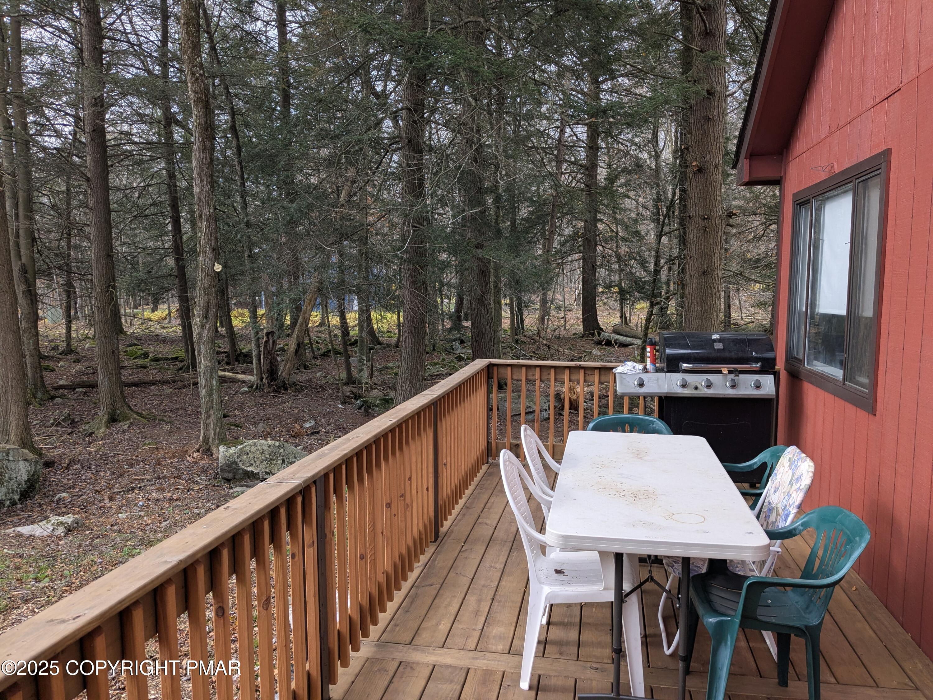 1027 Valley Road Newfoundland, PA 18445 - Photo 22 of 28 a view of a balcony with table and chairs