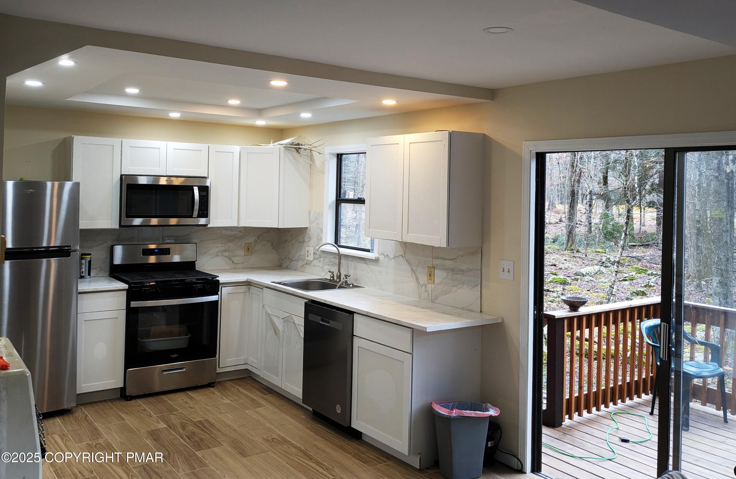 1027 Valley Road Newfoundland, PA 18445 - Photo 9 of 28 a kitchen with a sink stove and refrigerator