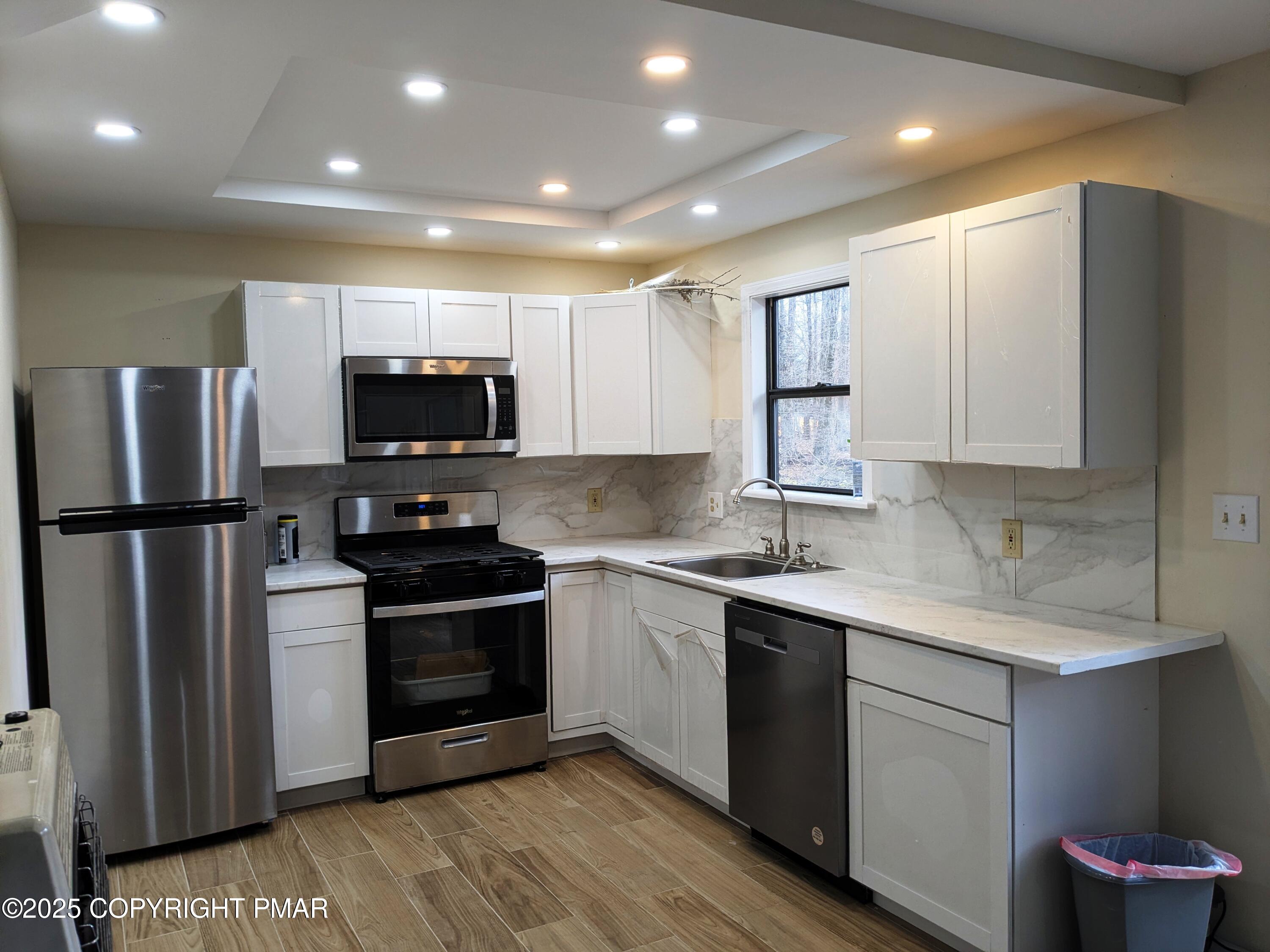 1027 Valley Road Newfoundland, PA 18445 - Photo 10 of 28 a kitchen with stainless steel appliances granite countertop a stove a sink and a refrigerator