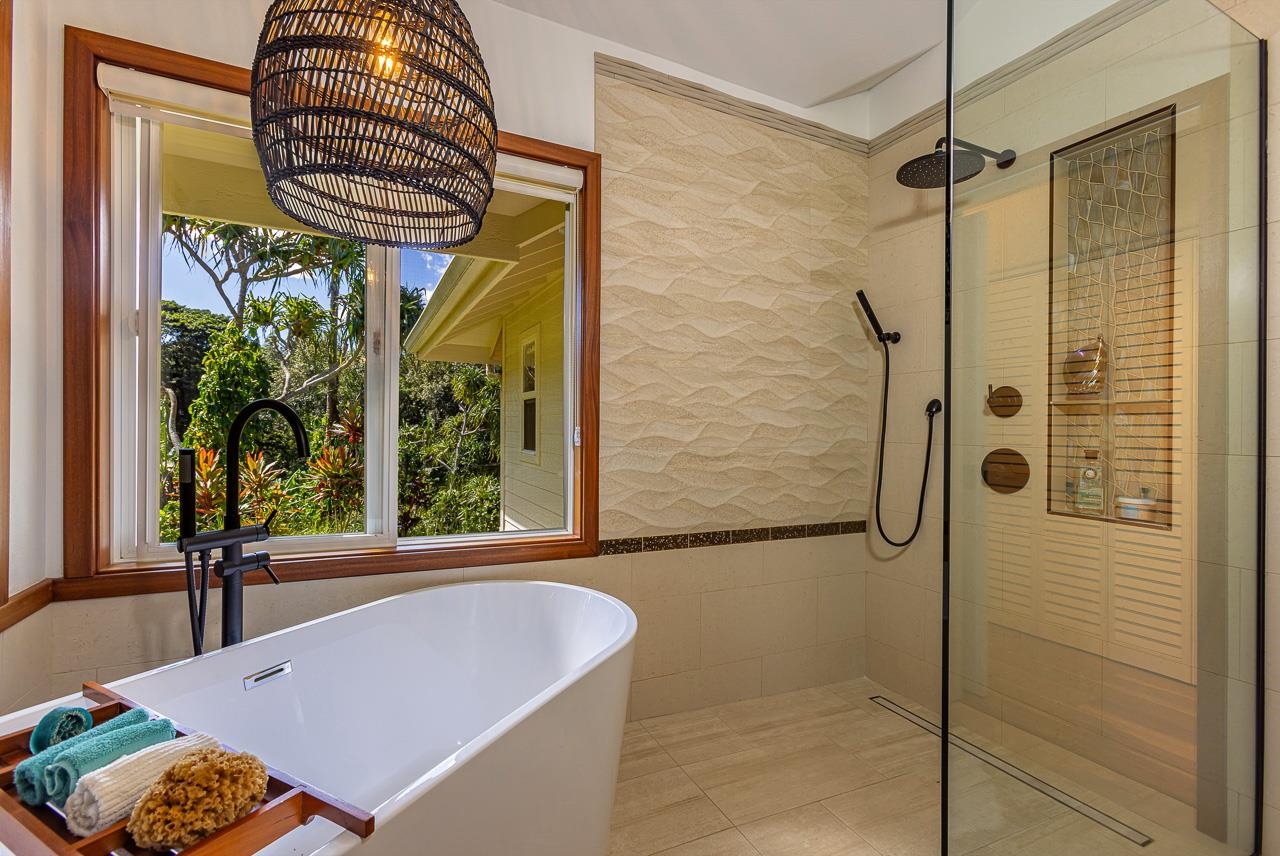 555 North Holokai Road Haiku, HI 96708 - Photo 33 of 50 Bathroom three offers a deep soaking spa tub & a spacious walk-in shower with an iridescent