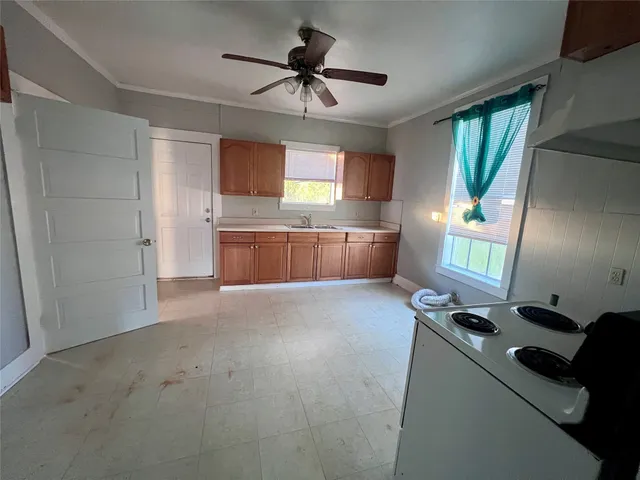a kitchen with microwave a stove and a refrigerator