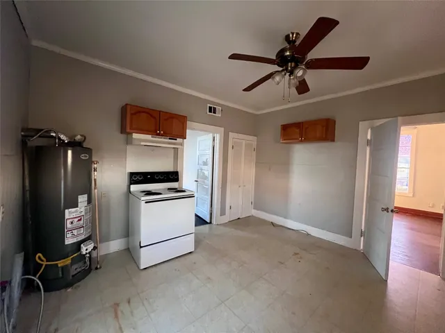 a view of a livingroom with a piano and a ceiling fan