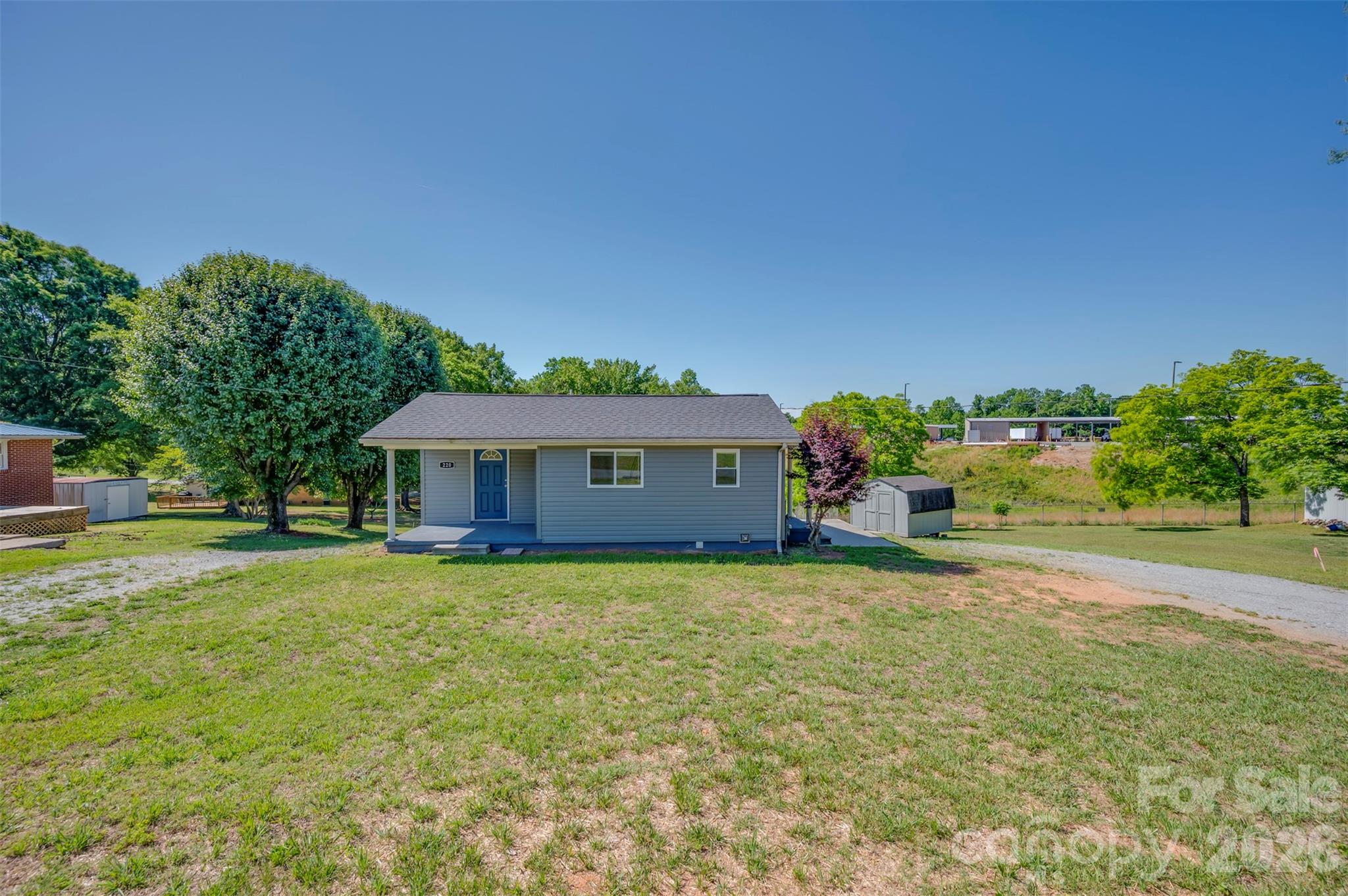 220 Roberson Road Forest City, NC 28043 - Photo 1 of 35 a front view of a house with a yard and garage