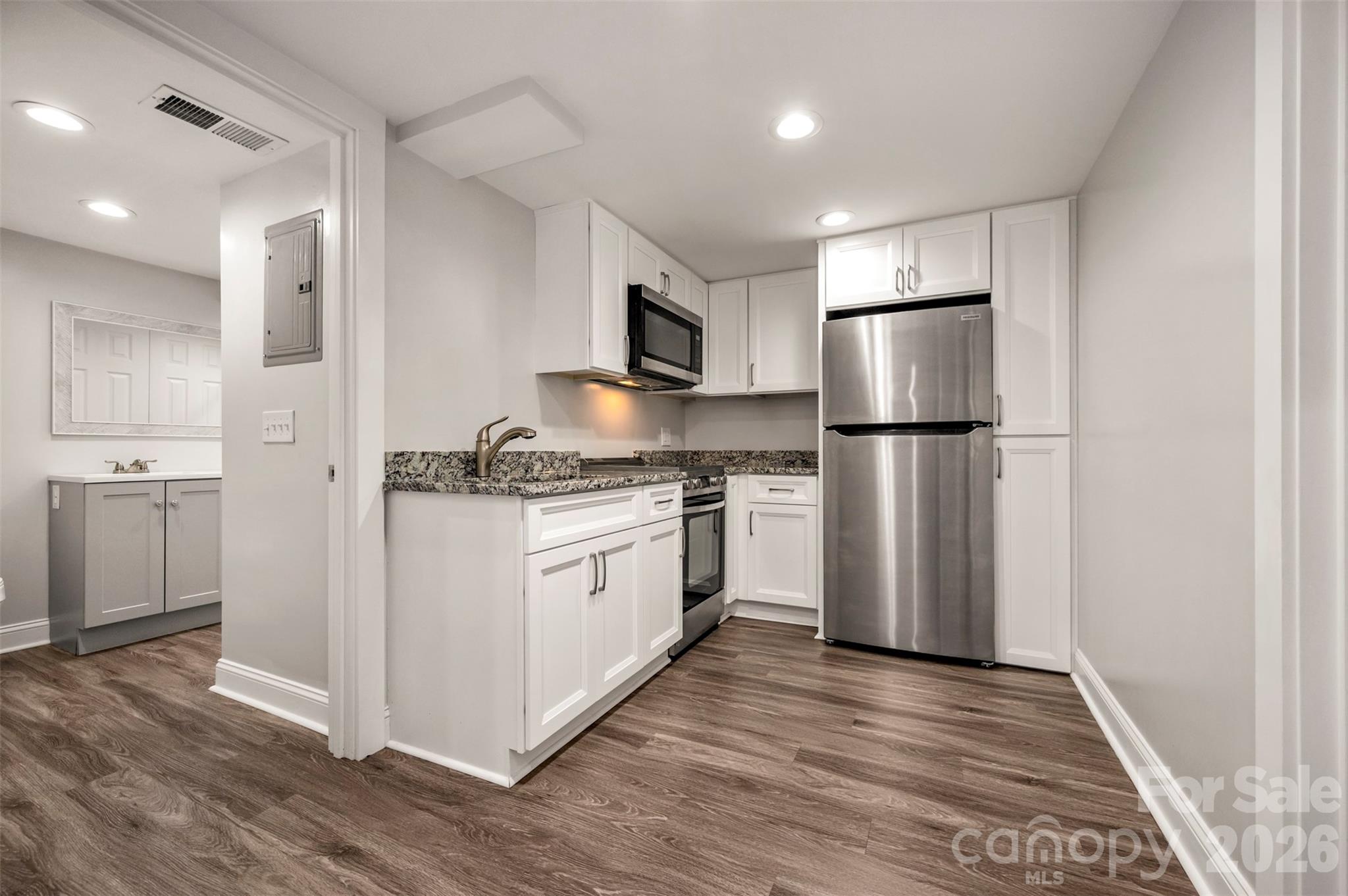 220 Roberson Road Forest City, NC 28043 - Photo 20 of 35 a kitchen with white cabinets and stainless steel appliances