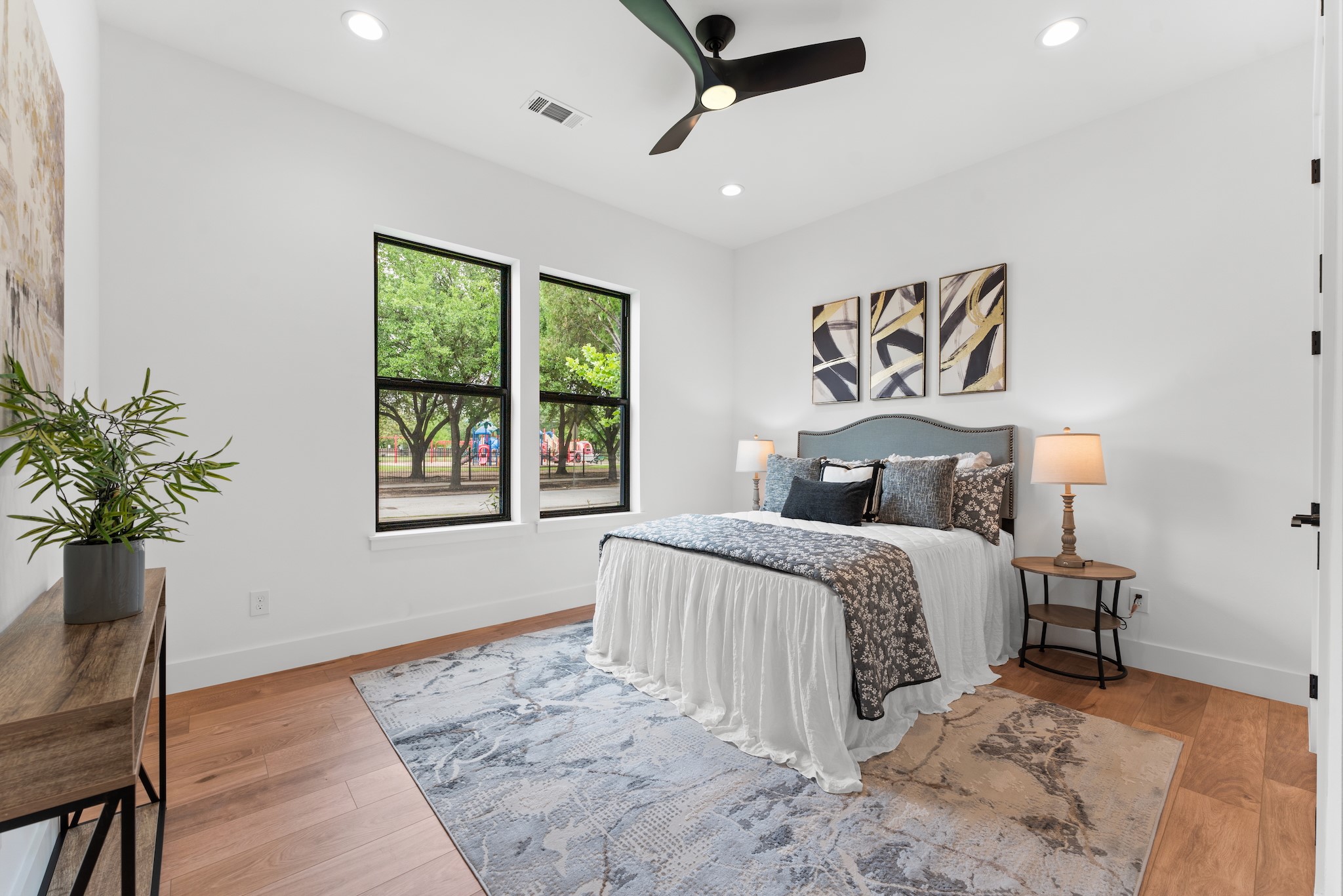 6711 Housman Houston, TX 77055 - Photo 30 of 49 a bedroom with a large bed and a potted plant