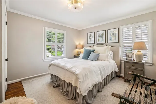 a bedroom with a bed and windows