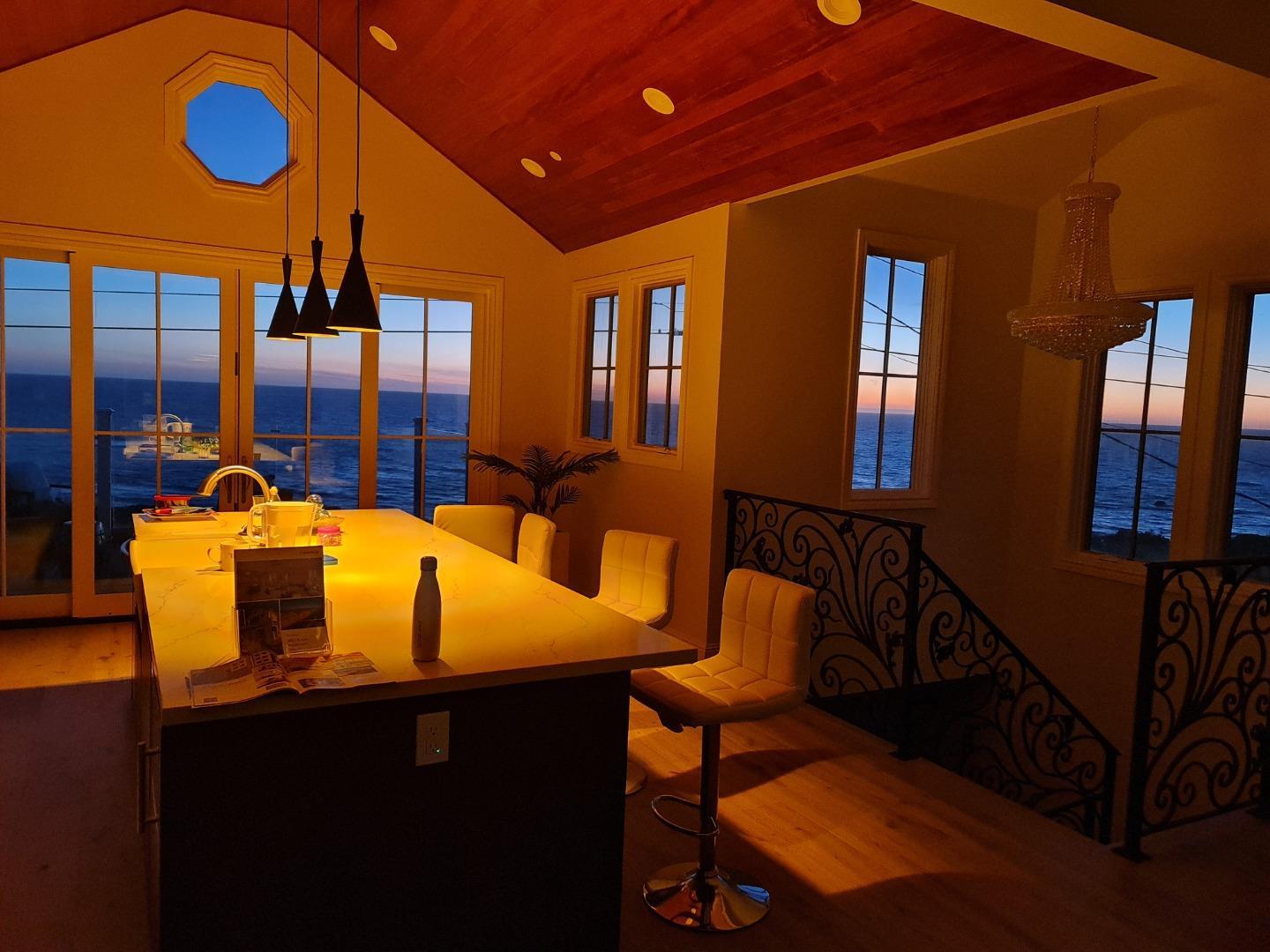 989 Ocean Boulevard Moss Beach, CA 94038 - Photo 11 of 44 a view of a dining room with furniture and chandelier