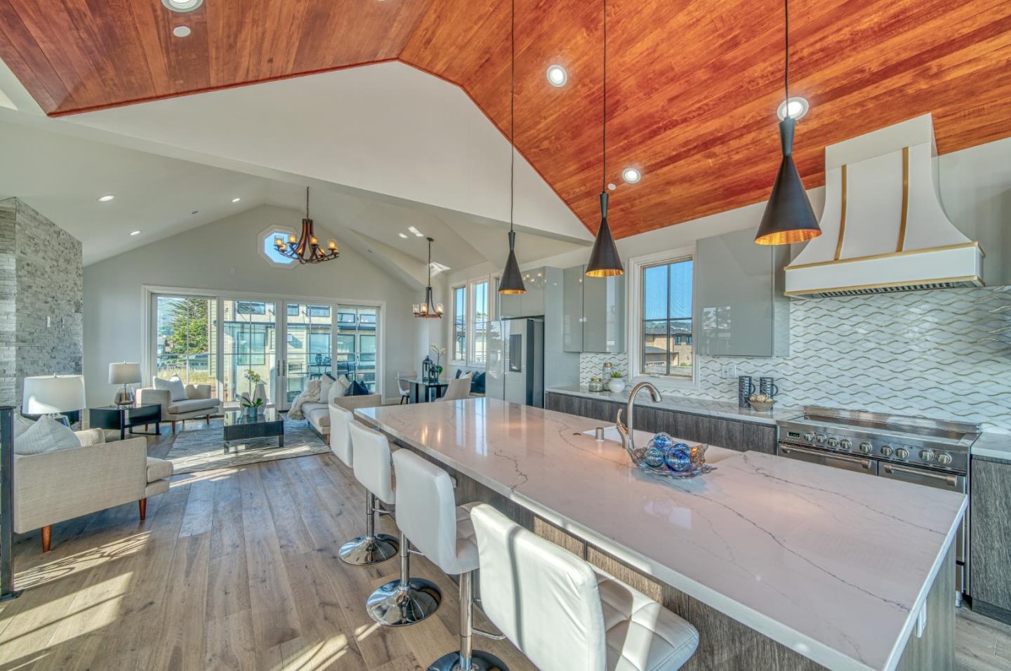 989 Ocean Boulevard Moss Beach, CA 94038 - Photo 17 of 44 a view of a kitchen with kitchen island a large window a sink and counter space