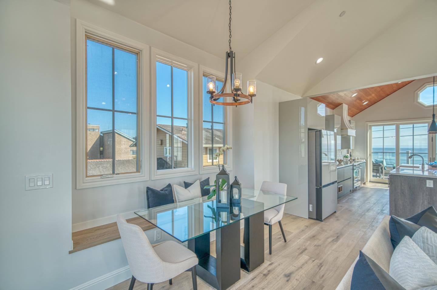 989 Ocean Boulevard Moss Beach, CA 94038 - Photo 19 of 44 a view of a dining room with furniture wooden floor and chandelier