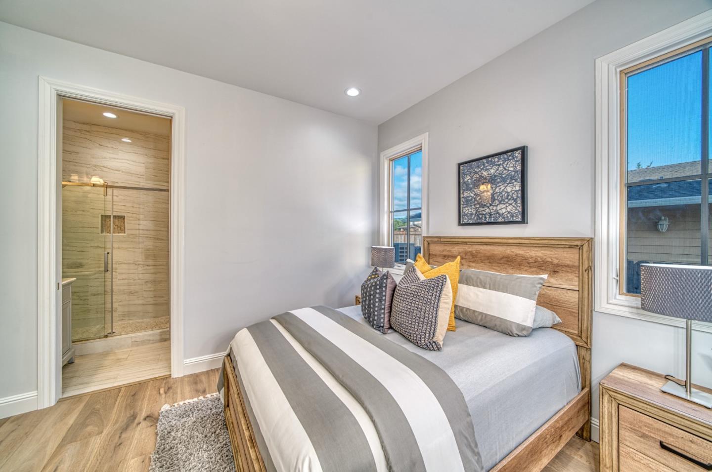 989 Ocean Boulevard Moss Beach, CA 94038 - Photo 25 of 44 a bedroom with a bed and a painting on the wall