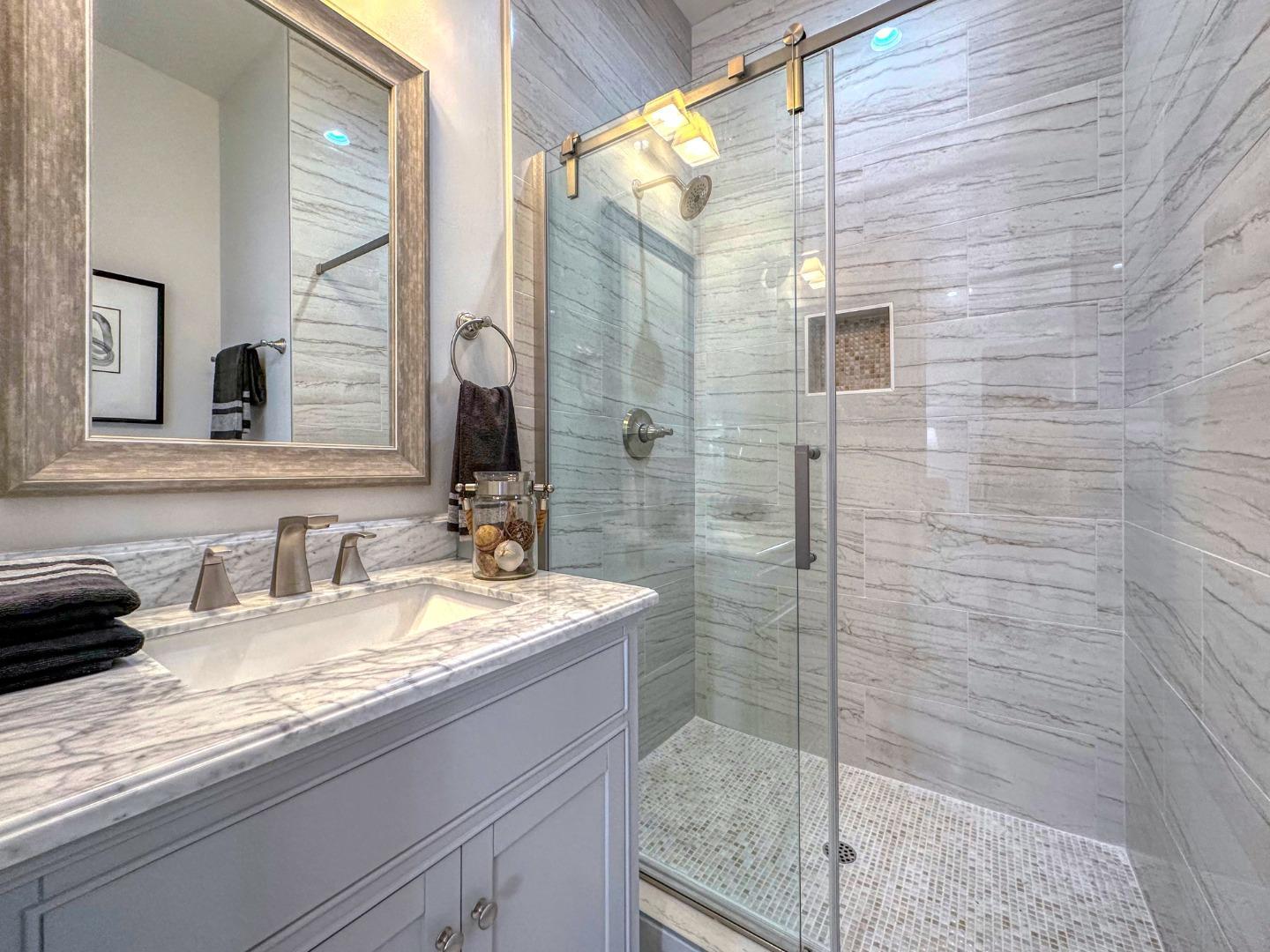 989 Ocean Boulevard Moss Beach, CA 94038 - Photo 26 of 44 a bathroom with a granite countertop sink a mirror and shower