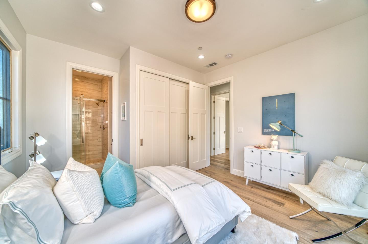 989 Ocean Boulevard Moss Beach, CA 94038 - Photo 28 of 44 a bedroom with a bed and wooden floor