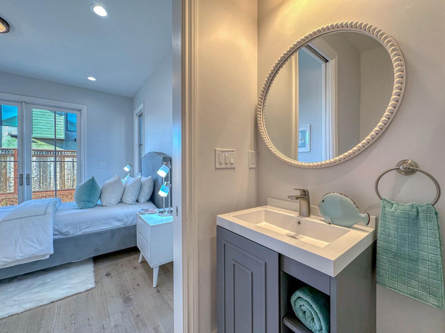 989 Ocean Boulevard Moss Beach, CA 94038 - Photo 29 of 44 a bedroom with a bed and a mirror