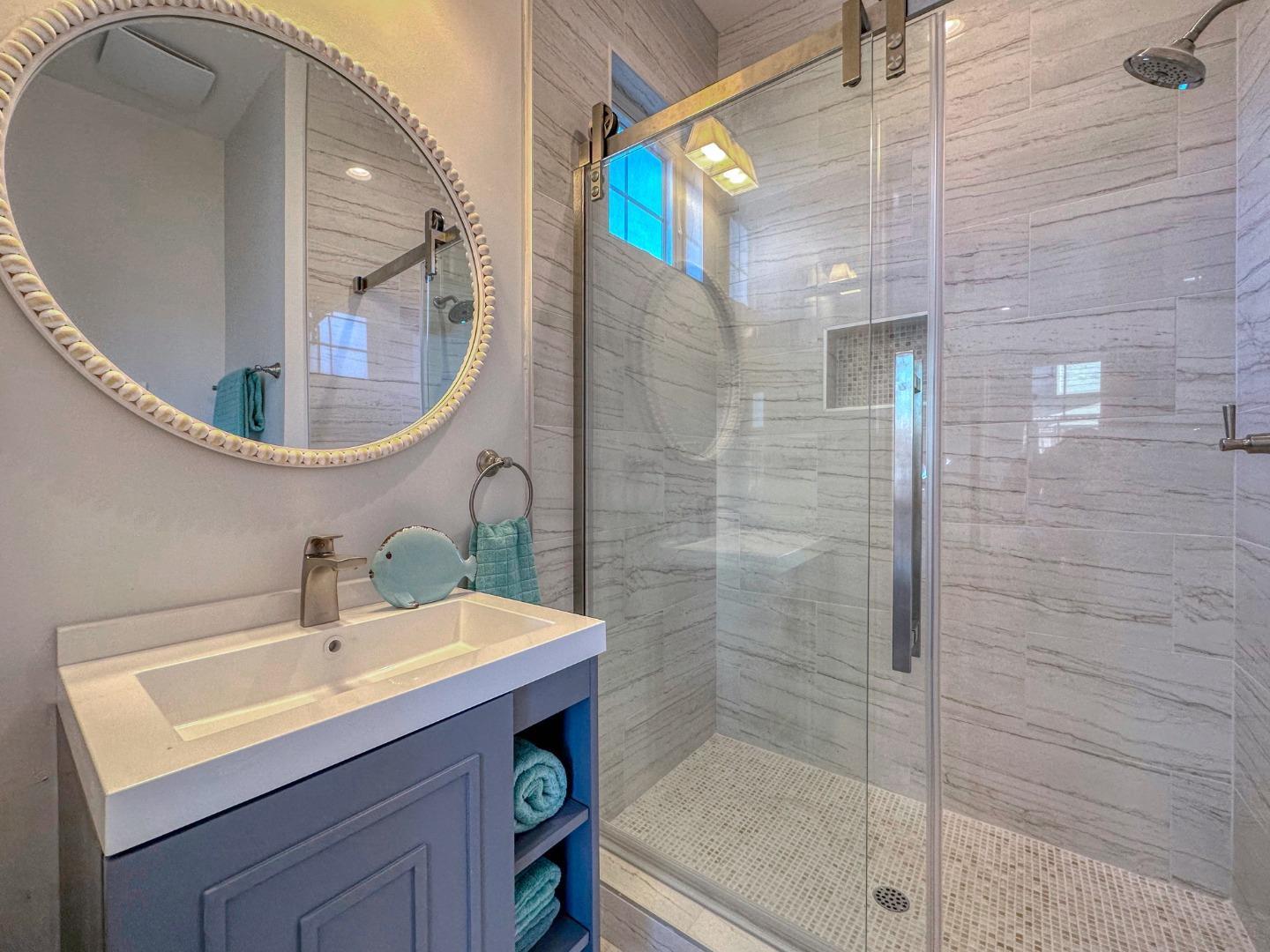 989 Ocean Boulevard Moss Beach, CA 94038 - Photo 30 of 44 a bathroom with a sink a mirror and a shower