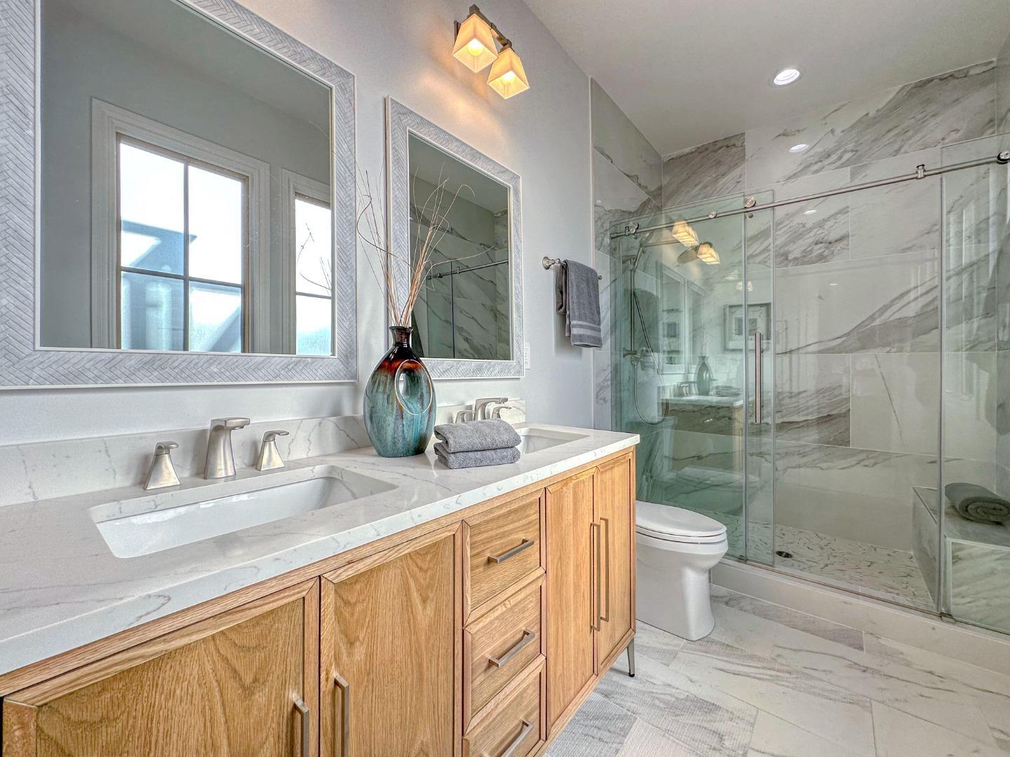 989 Ocean Boulevard Moss Beach, CA 94038 - Photo 33 of 44 a bathroom with a granite countertop sink mirror vanity and toilet