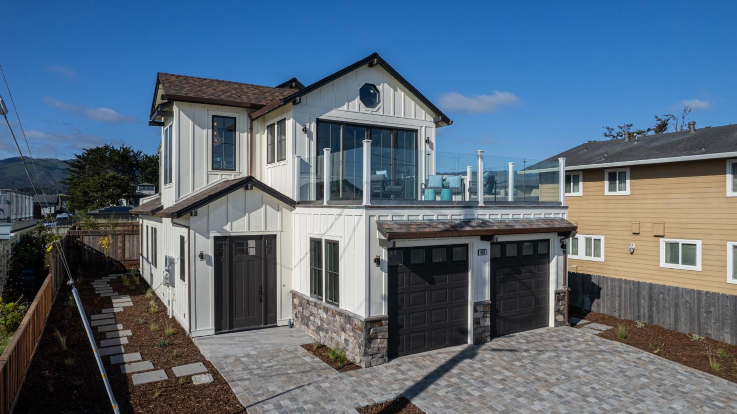 989 Ocean Boulevard Moss Beach, CA 94038 - Photo 39 of 44 a front view of a house with glass windows