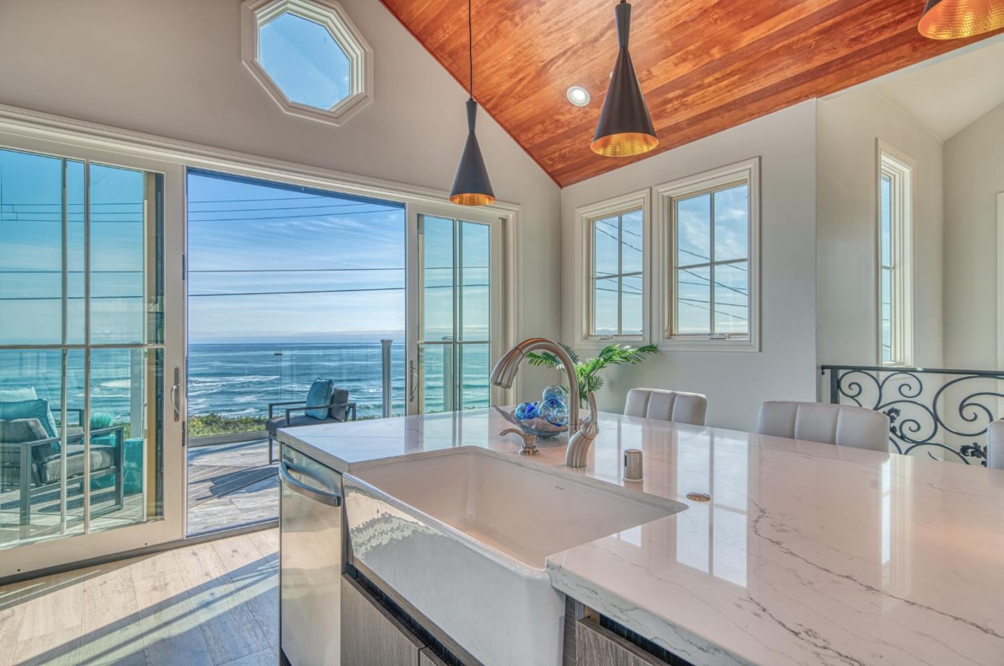 989 Ocean Boulevard Moss Beach, CA 94038 - Photo 9 of 44 a view of a kitchen island a potted plant and a sink