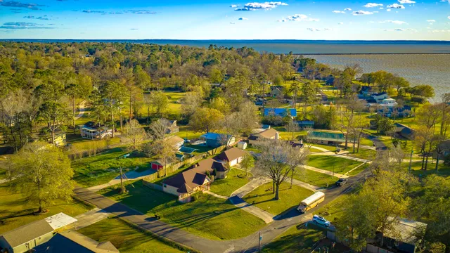 an aerial view of a house with garden space and street view