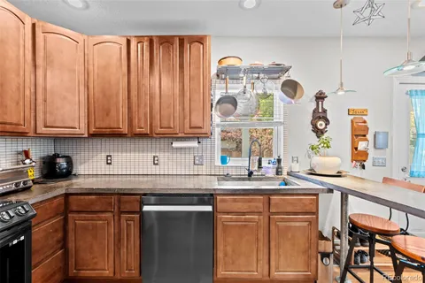 a kitchen with stainless steel appliances granite countertop a sink and cabinets