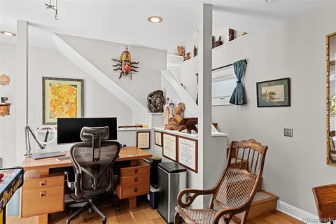 a view of a workspace with furniture and a window