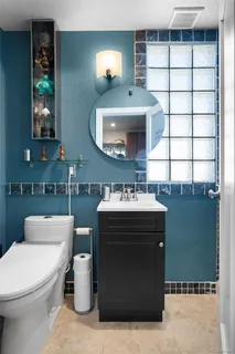 a bathroom with a sink toilet and mirror