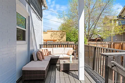 a view of a balcony with chair and wooden floor