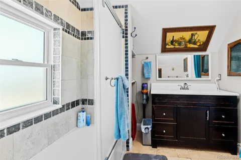 a bathroom with a sink vanity and a mirror