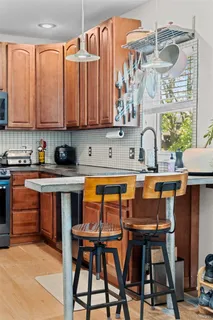 a kitchen with a sink a stove and white cabinets