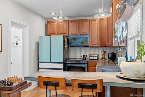 a kitchen with stainless steel appliances granite countertop a refrigerator and microwave