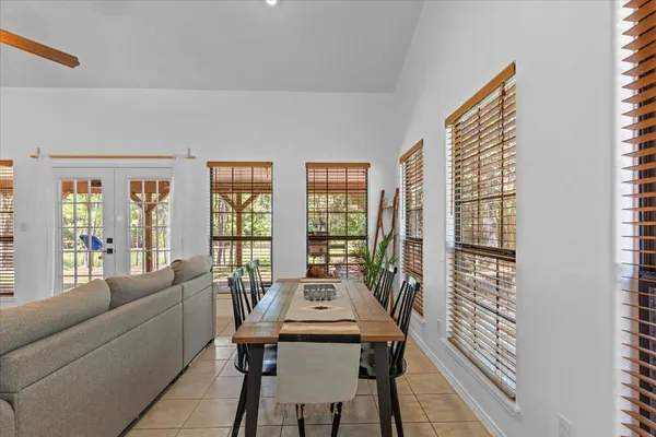 a living room with furniture and large windows