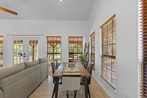 a living room with furniture and large windows