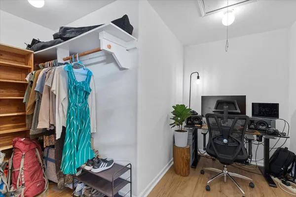 a view of a workspace with furniture and wooden floor