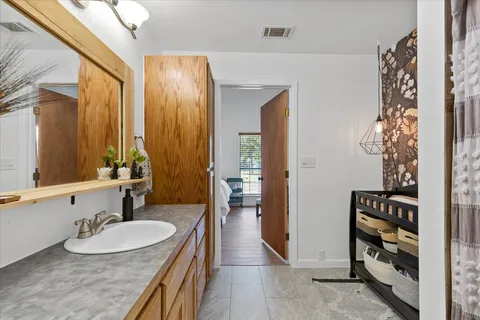 a bathroom with a granite countertop sink mirror and toilet
