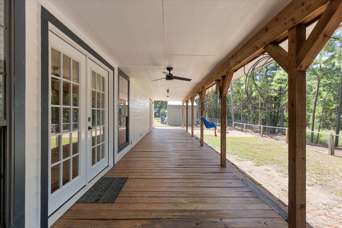 120 Lake Point Way Bastrop, TX 78602 - Photo 28 of 40 a view of a porch with wooden floor and stairs