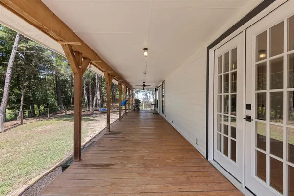 a view of a porch with wooden floor and stairs