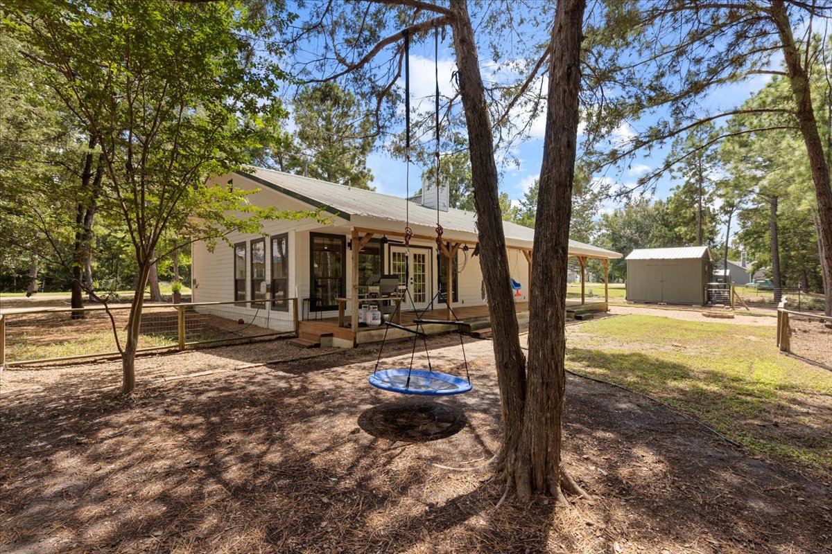 120 Lake Point Way Bastrop, TX 78602 - Photo 31 of 40 a view of a house with backyard and a tree