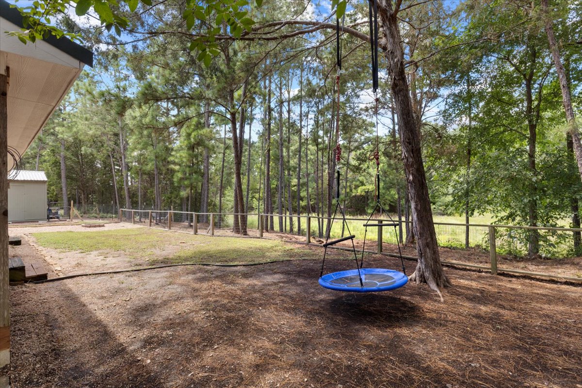 120 Lake Point Way Bastrop, TX 78602 - Photo 32 of 40 a view of a backyard with large trees