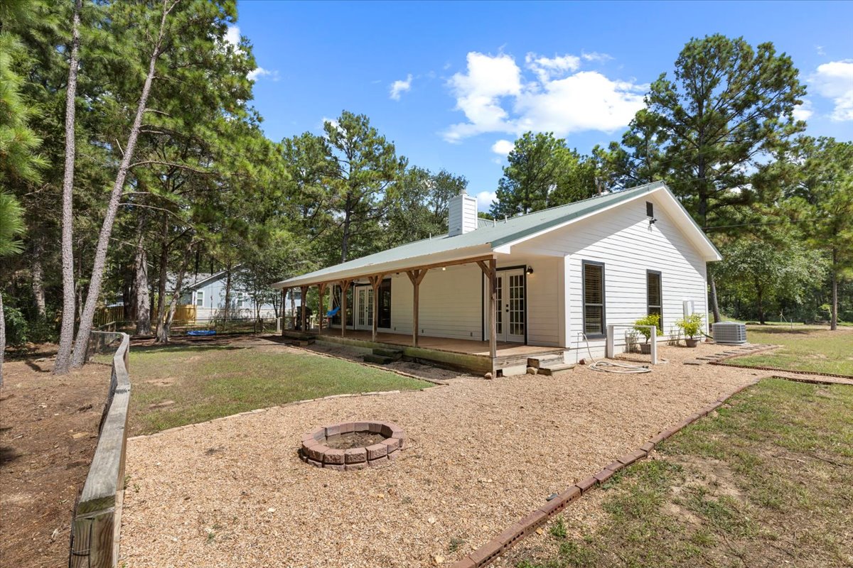 120 Lake Point Way Bastrop, TX 78602 - Photo 33 of 40 a view of a white house with a yard and sitting area