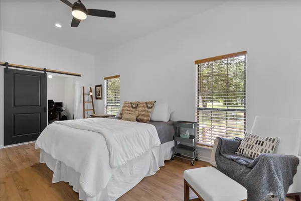 a bedroom with a bed couch and a window