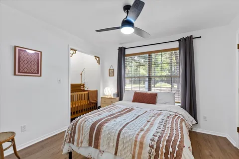 a bedroom with a large bed and a window