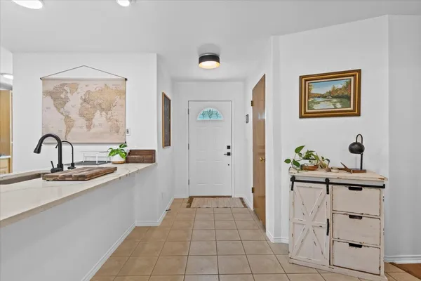 a view of a hallway with kitchen