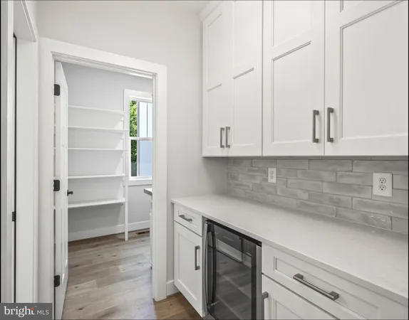 a large kitchen with kitchen island a stove a sink a center island and wooden floor
