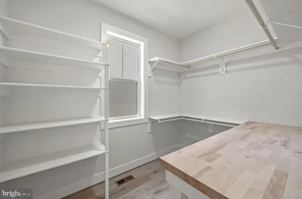 a kitchen with white cabinets and a sink