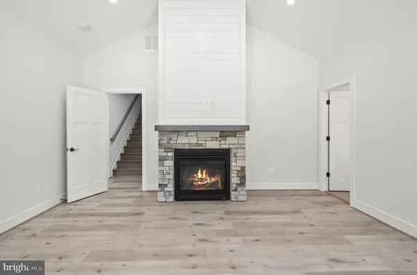 an empty room with wooden floor and a window