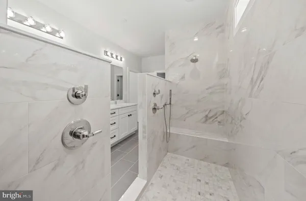 a bathroom with a sink double vanity granite tub and shower