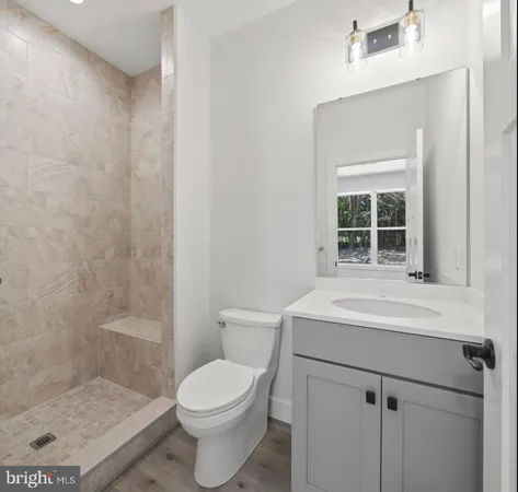 a spacious bathroom with a toilet sink and mirror