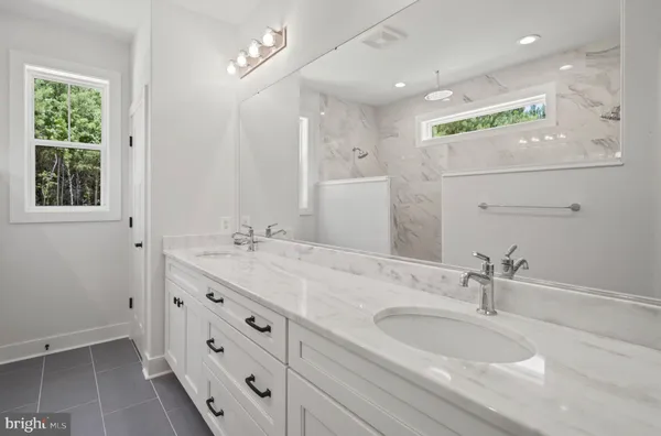 a bathroom with a double vanity sink and a mirror