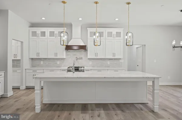 a kitchen with stainless steel appliances white cabinets and a stove